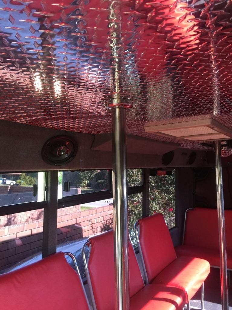 Aisle and pole inside the 21 seater party bus