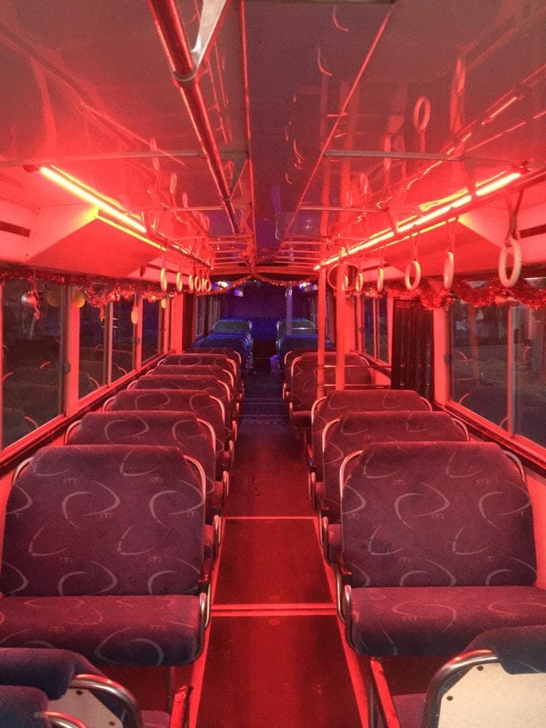 Interior of the 70 seater party bus under red lighting